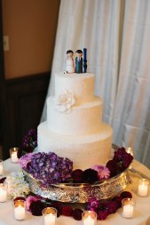 Custom wedding cake and topper with purple flowers